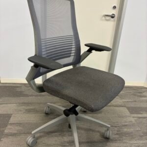 A used Sit On It Vectra ergonomic task chair featuring a slim profile, breathable micro mesh back, adjustable lumbar support with quick-adjust slide knobs, and fully adjustable cantilever arms.